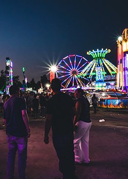 Night photo of a fair with colourful lights