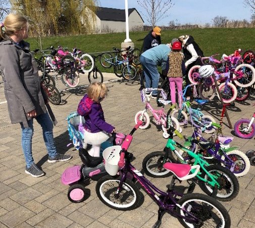 mother and children testing out bicycles