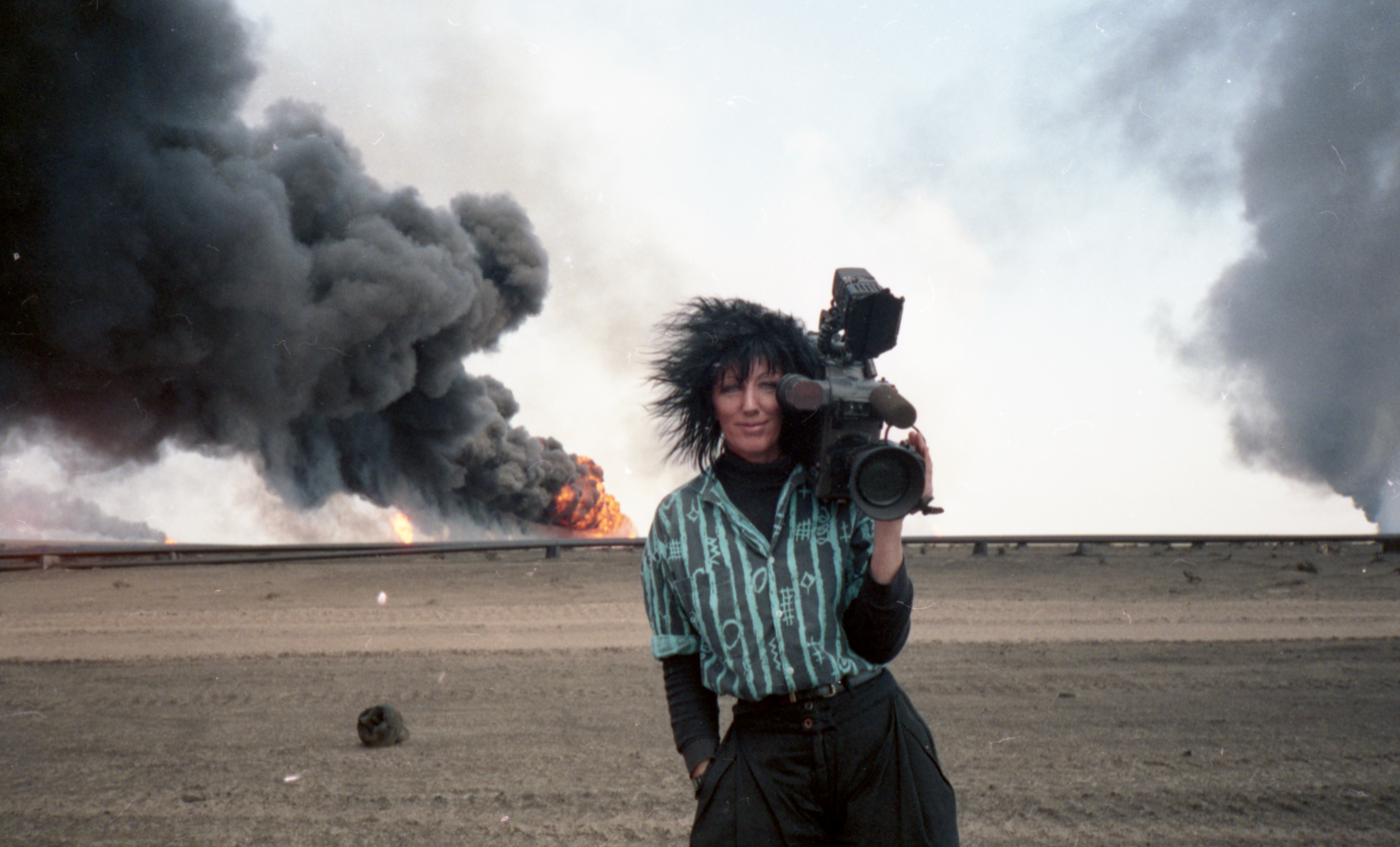 Woman with camera in front of explosion