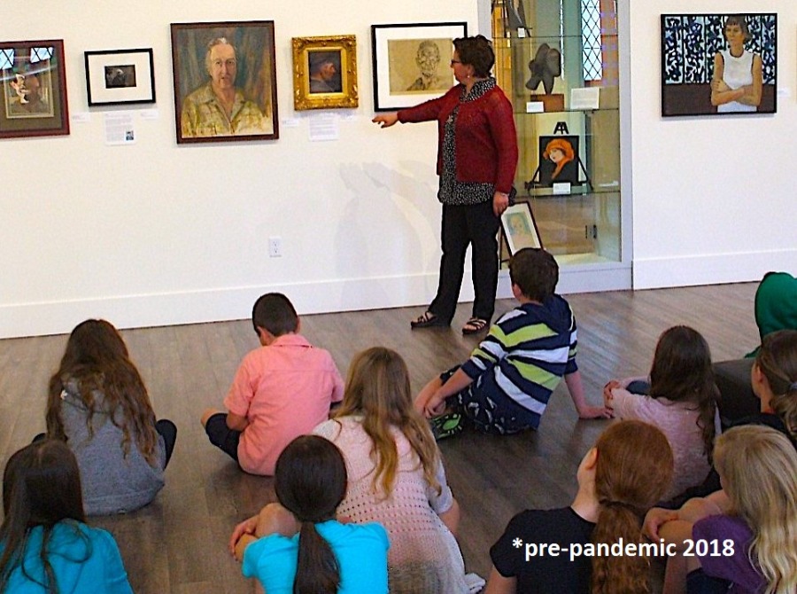 gallery curator showing artwork