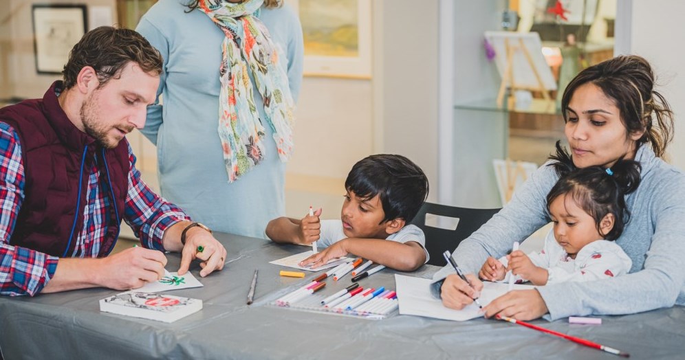 Two children holding artwork