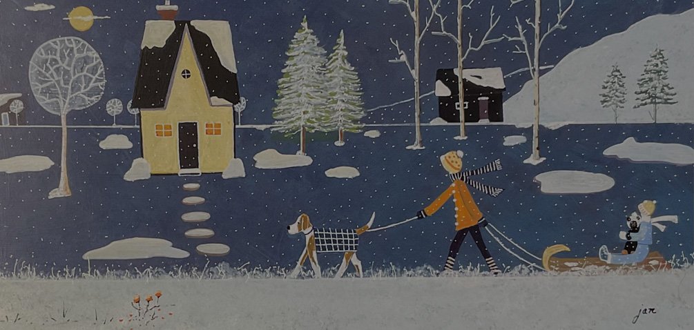Winter scene with a person in an orange coat and striped scarf walking a dog in a checkered coat. The person is pulling a sled carrying another individual holding a teddy bear. Snow covers the ground and is falling from the sky. In the background, there are two houses, one yellow with lights on and one dark. There are snow-covered trees and bushes
