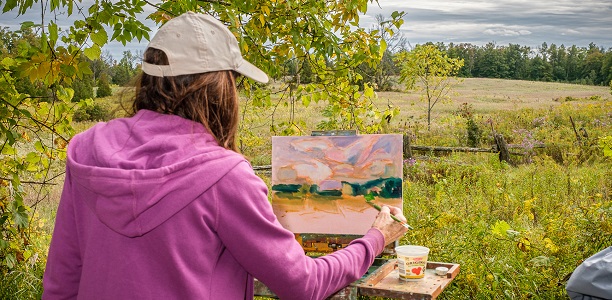 woman painting in field