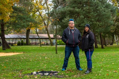 Two people standing in a park