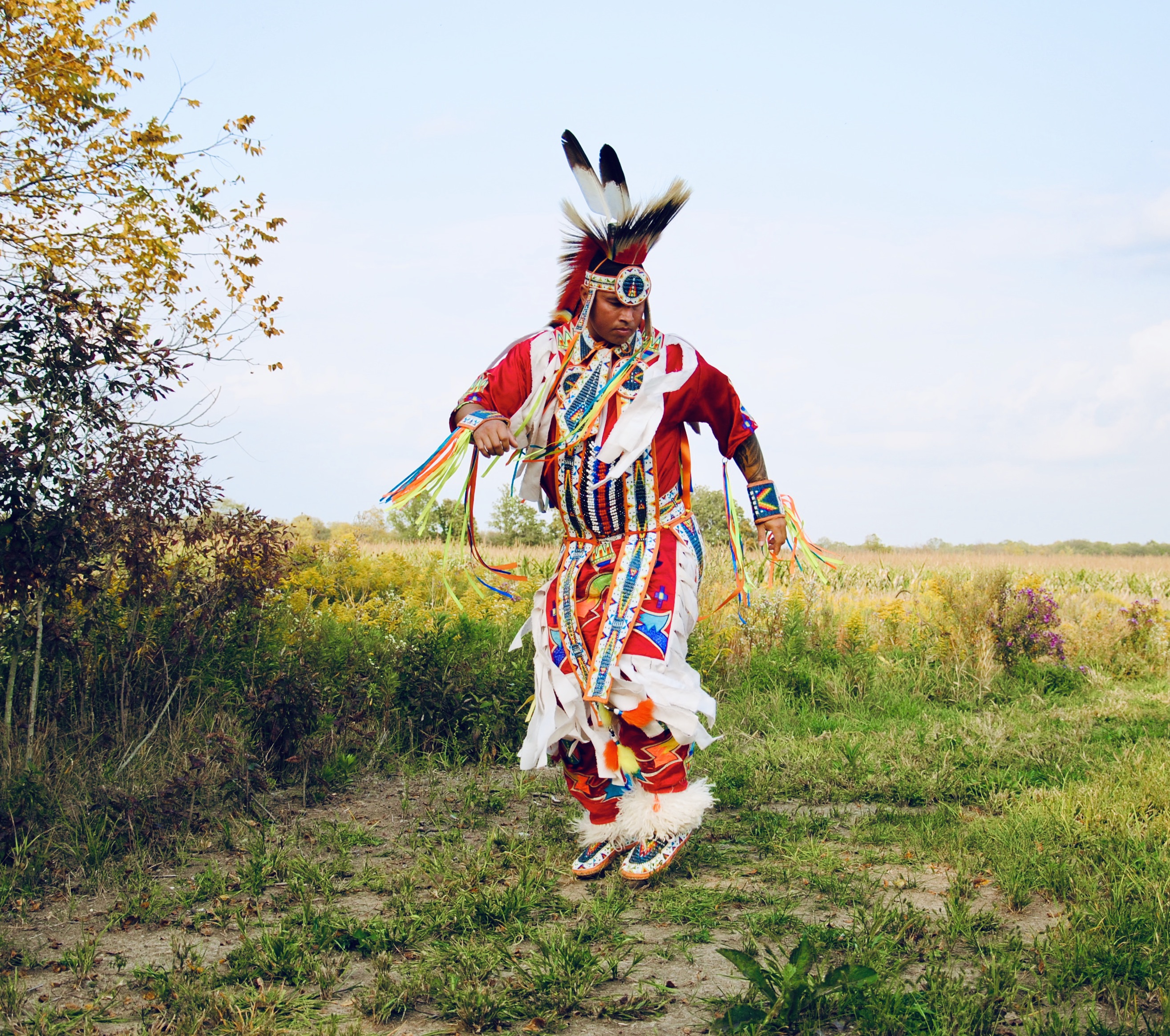 One performer stands in a field