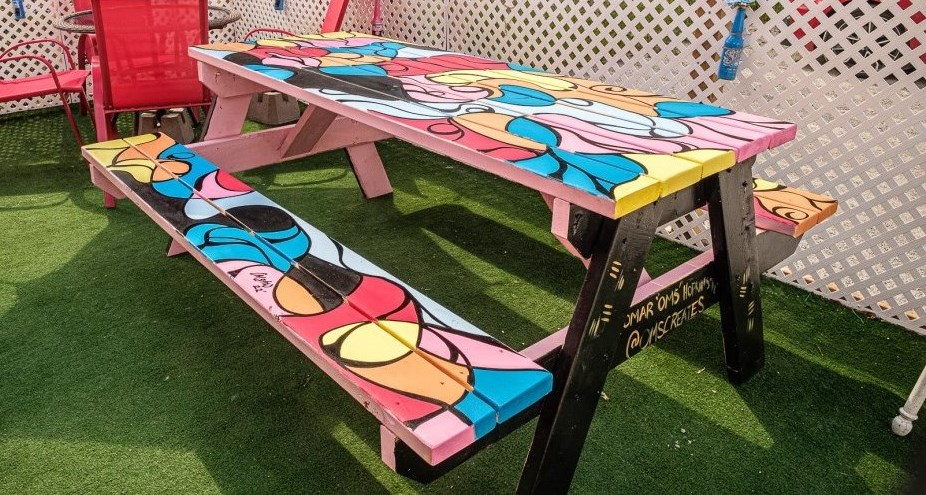 A colorful picnic table with abstract designs 
