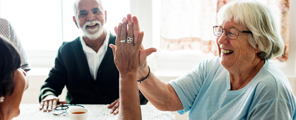 group of older adults having a joyful conversation together