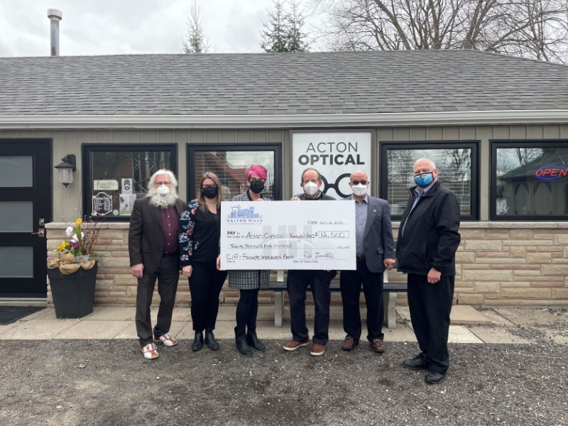 Image of Acton Optical Employees accepting cheque from elected officials