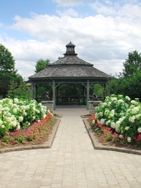 A gazebo behind manicured garden beds of white hydrangeas in Dominion Gardens Park in Georgetown