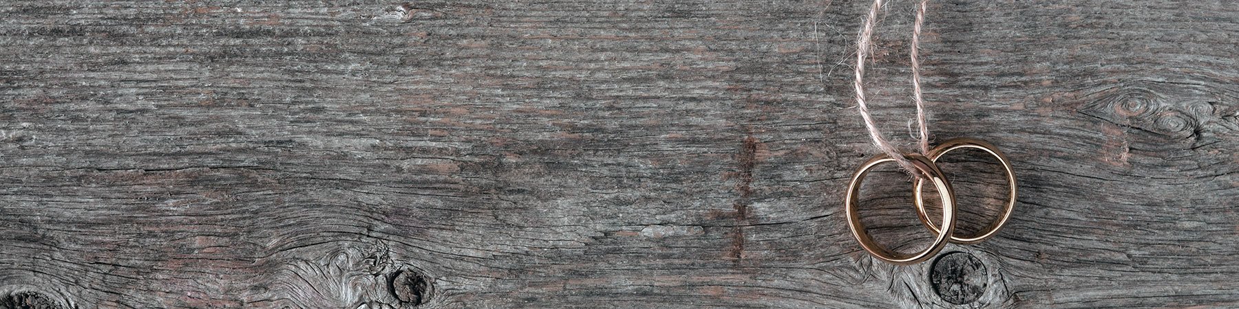 two wedding rings on a wood background