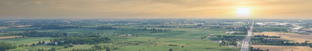 Town in the distance with the sun setting behind it